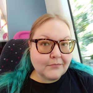 Purple on the train with greenish-blue hair